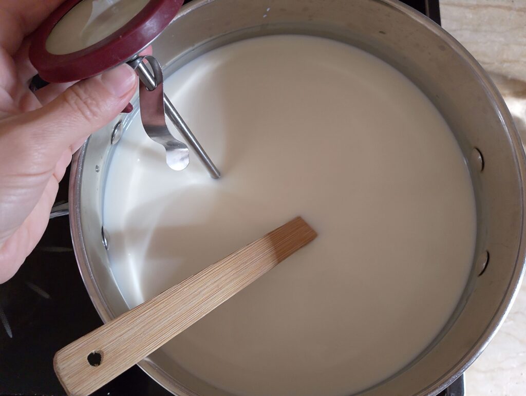 Heating raw milk in a pot for the queso fresco cheese