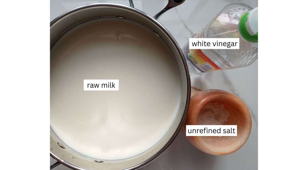 Ingredients for raw milk queso fresco: raw milk in a pot, vinegar in a bottle, and salt un a mortar