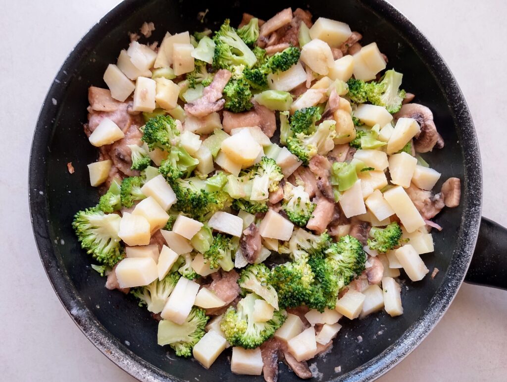 Warming the cubed potatoes and chopped broccoli for the savory bread and butter pudding