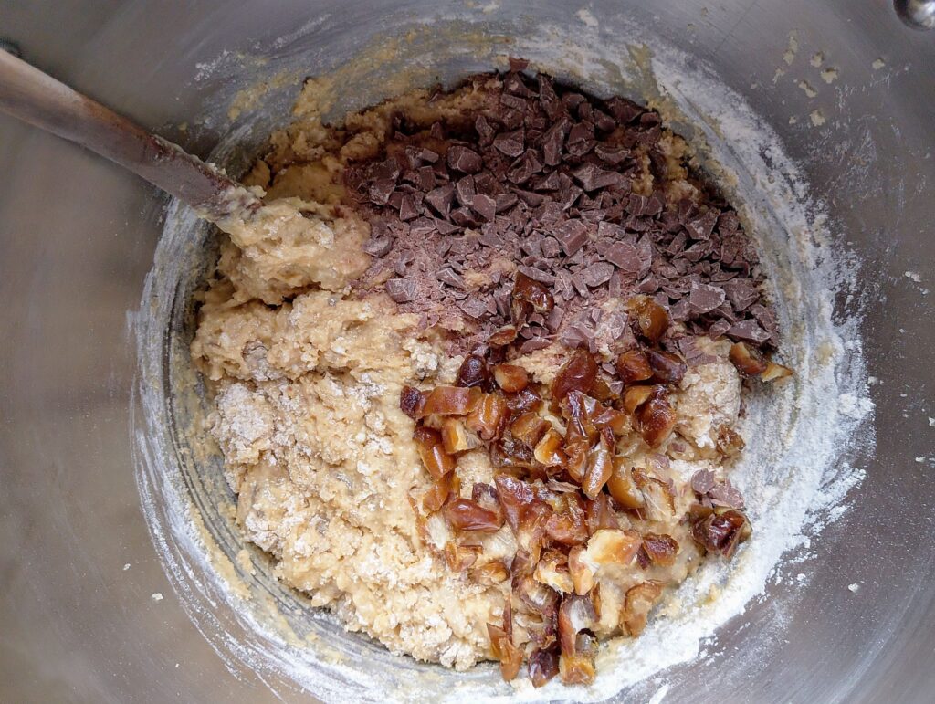 Adding chopped dates and chocolate chips into sourdough banana bread batter