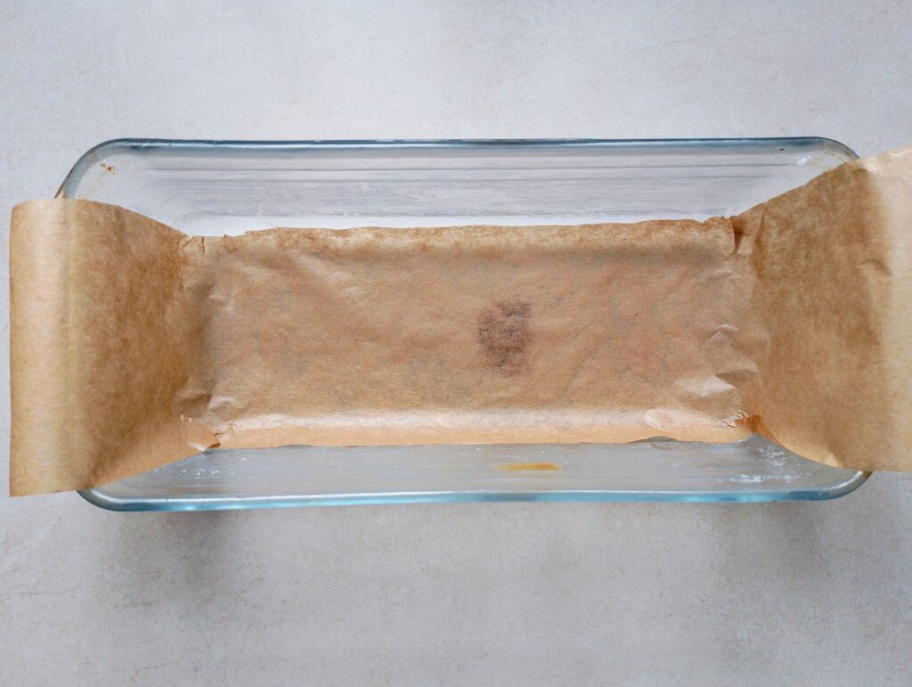 Greasing and lining a loaf pan for the sourdough discard banana bread