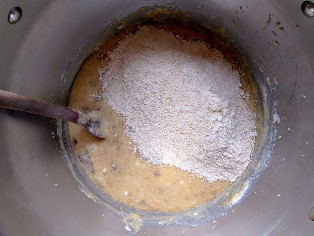 Adding dry ingredients into wet ingredients for the sourdough discard banana bread
