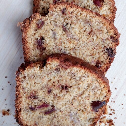 Slices of sourdough discard banana bread on wooden table