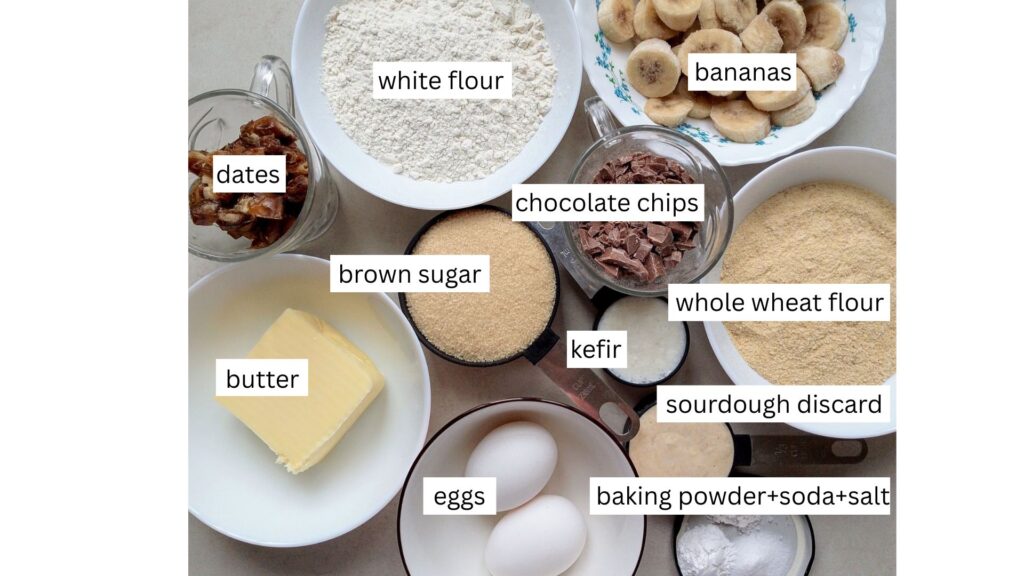Ingredients for sourdough discard banana bread arranged in bowls and cups on the counter top