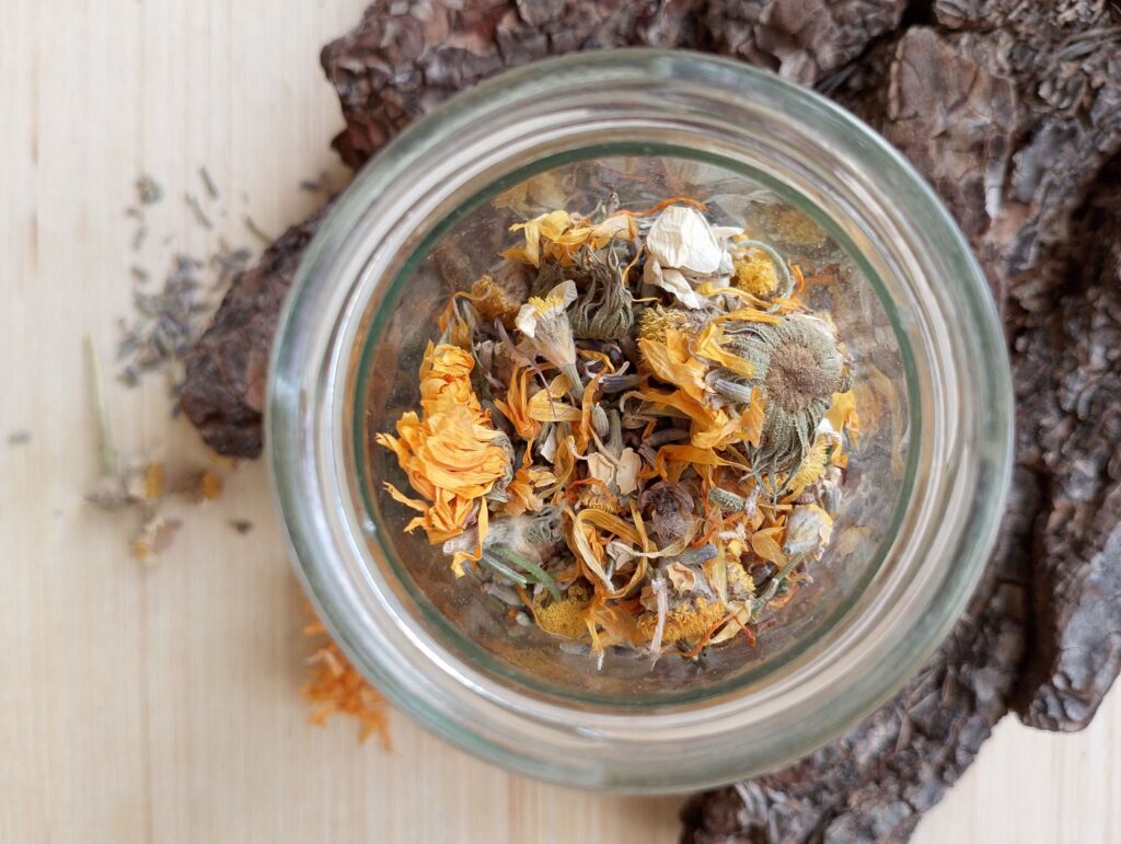 Ingredients for a DIY herbal steam facial in a glass jar