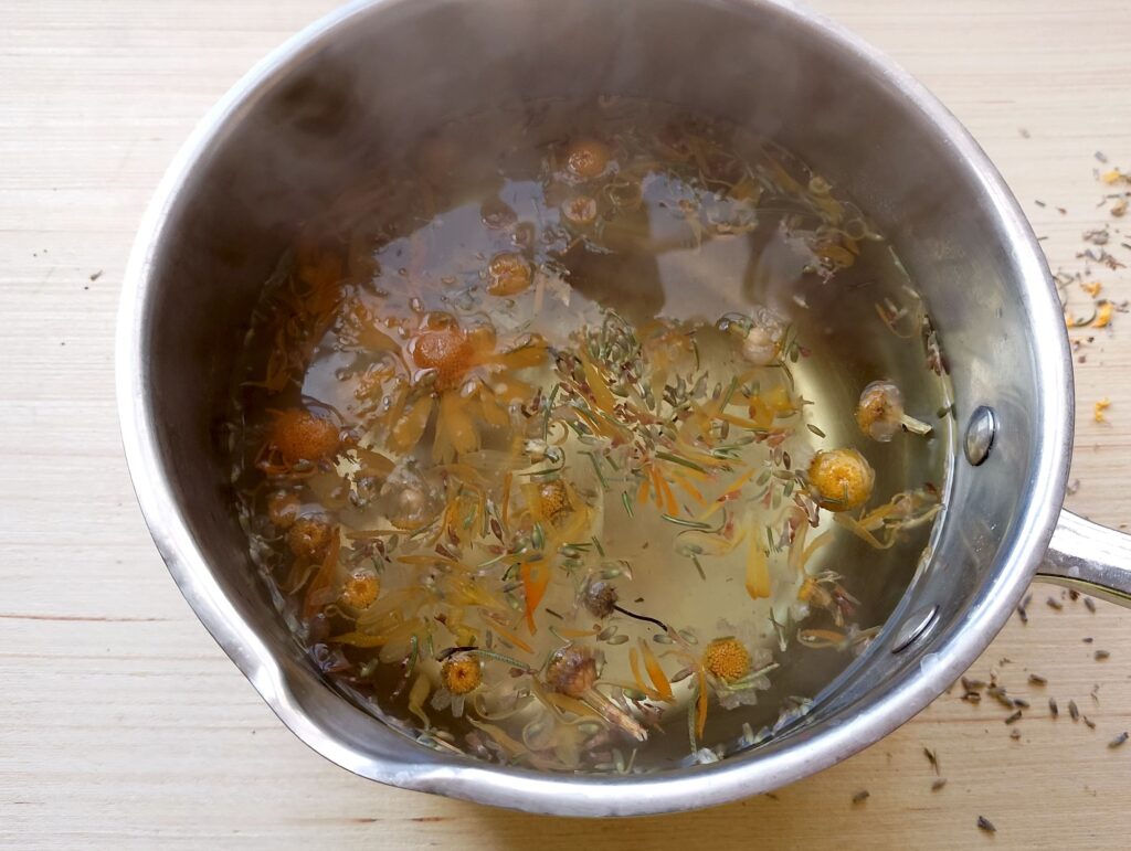 Infusing herbs in hot water for the herbal steam facial