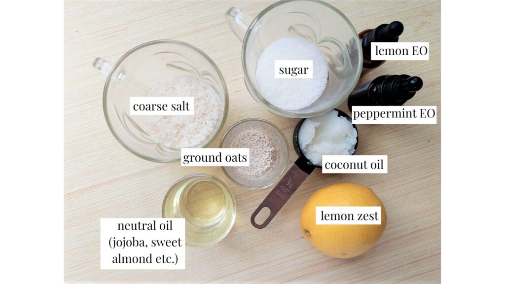 Ingredients for DIY lemon and peppermint foot scrub on a wooden table