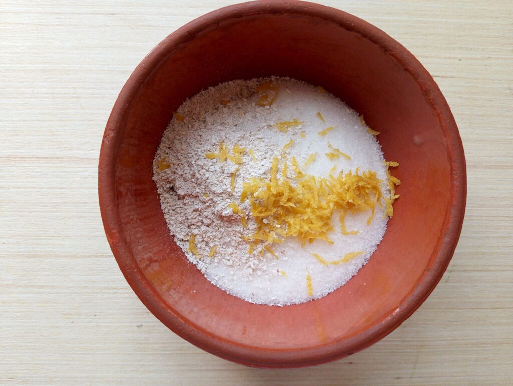 Placing dry ingredients for the diy foot scrub in a bowl