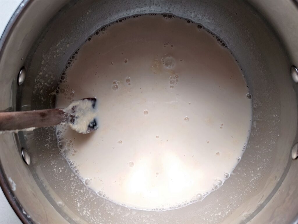 Mixing wet ingredients for the easy sourdough pita bread in a metal bowl