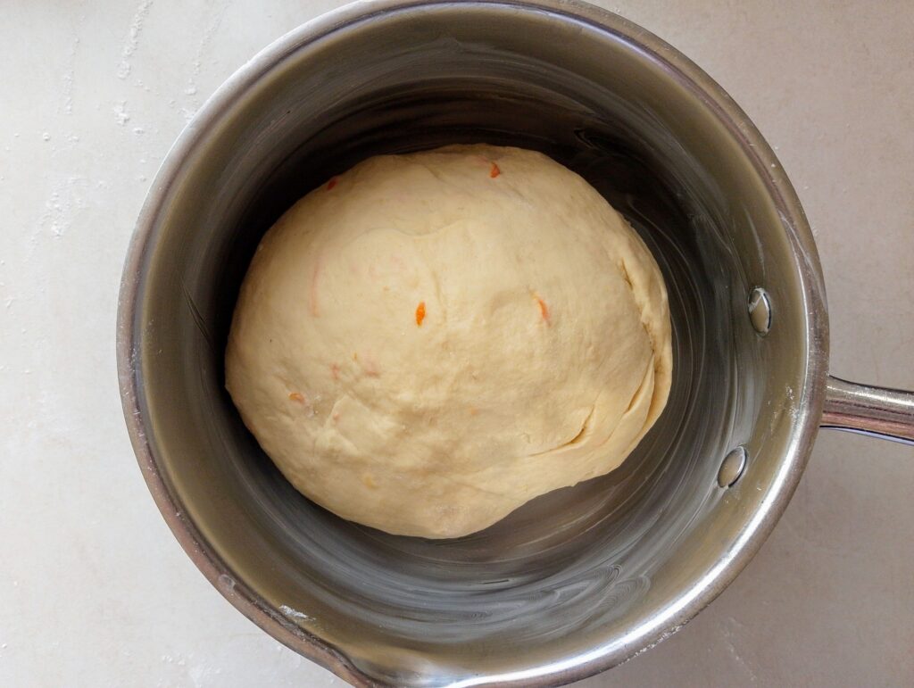 Placing cinnamon rolls dough in a oiled bowl to let it bulk ferment