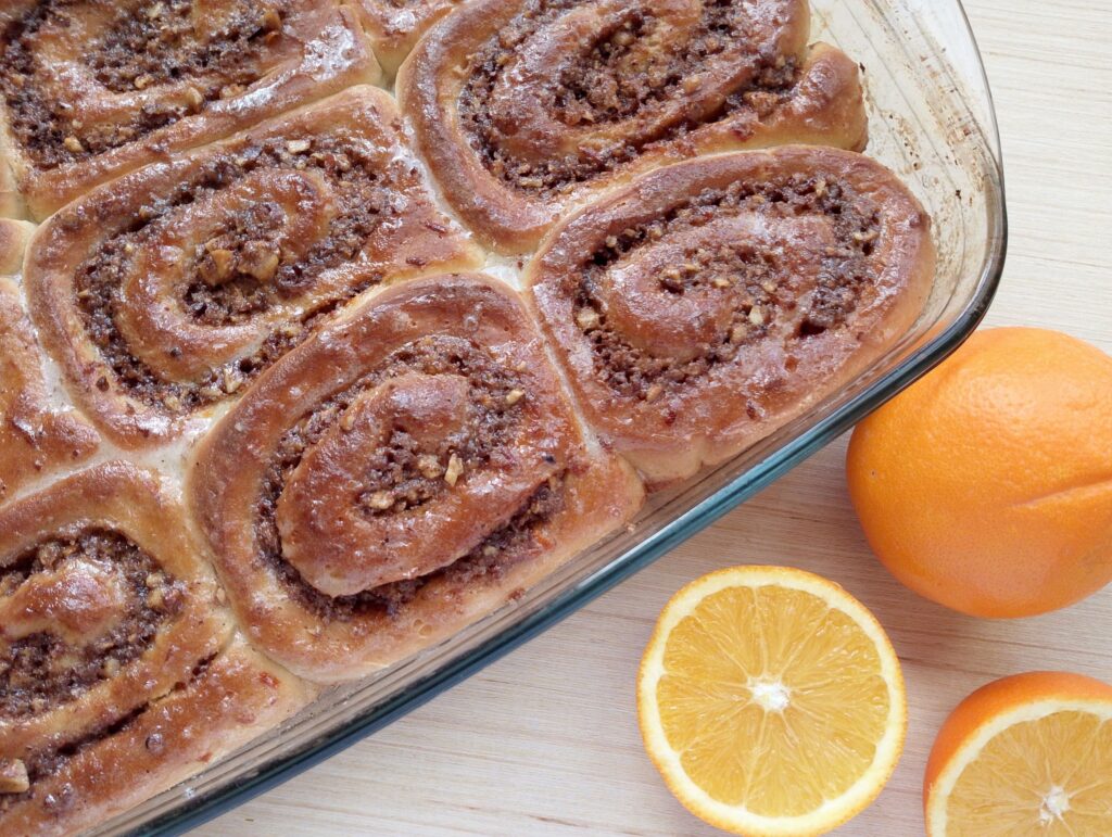 Freshly baked orange cinnamon rolls with orange glaze added on top