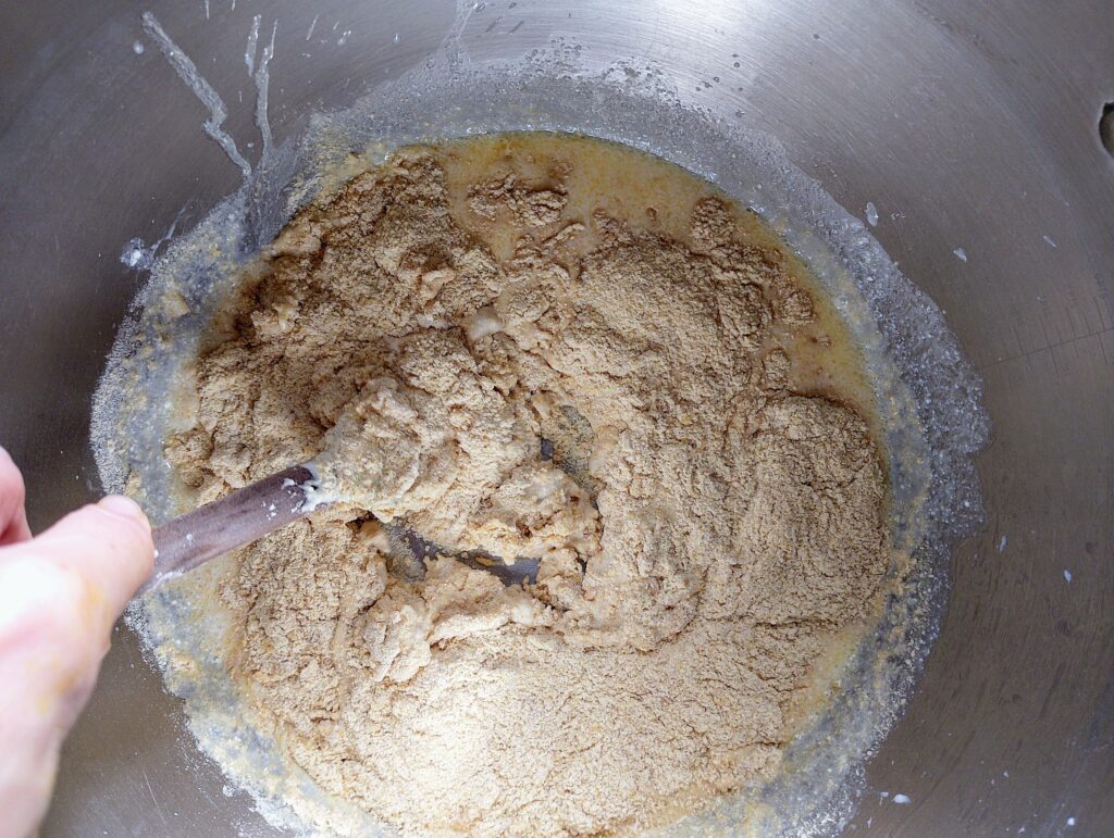Adding in flour into the liquid ingredients for the sourdough naan