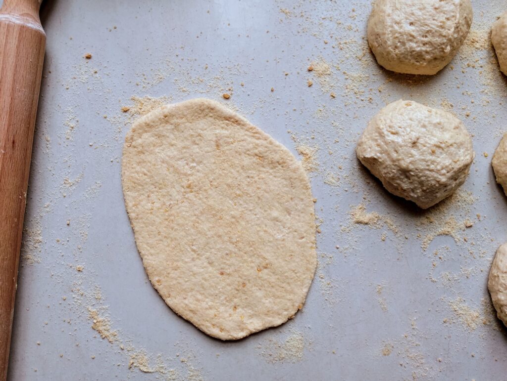 Rolling out the dough pieces into ovals