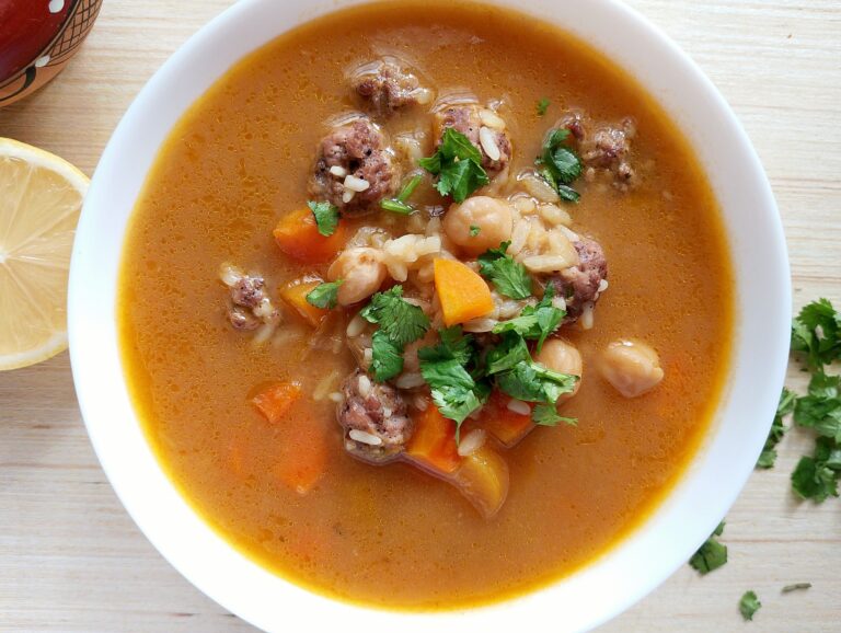 Turkish meatball soup in a bowl, garnished with fresh chopped cilantro