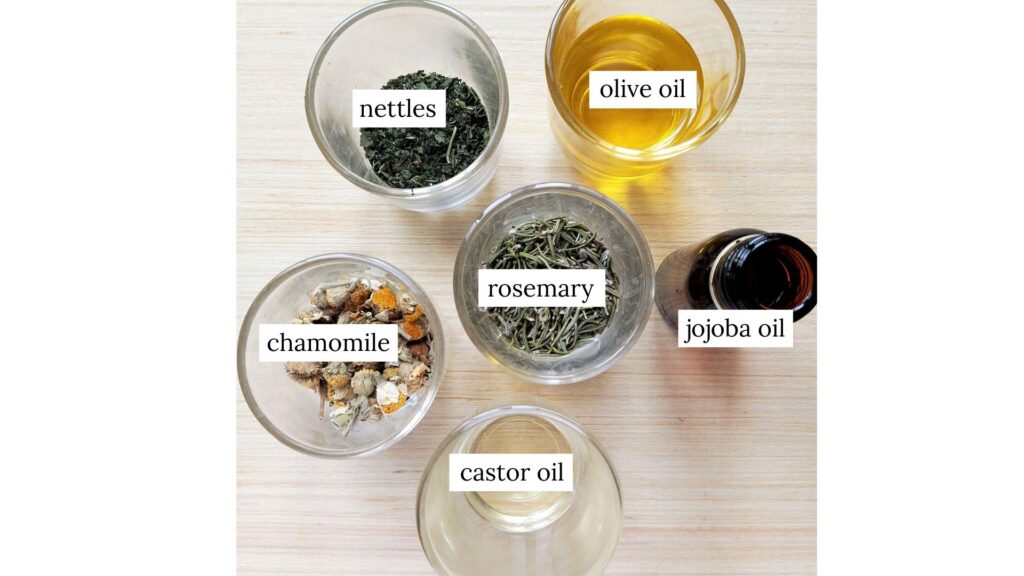 Ingredients for DIY hair and scalp oil in cups on a wooden table