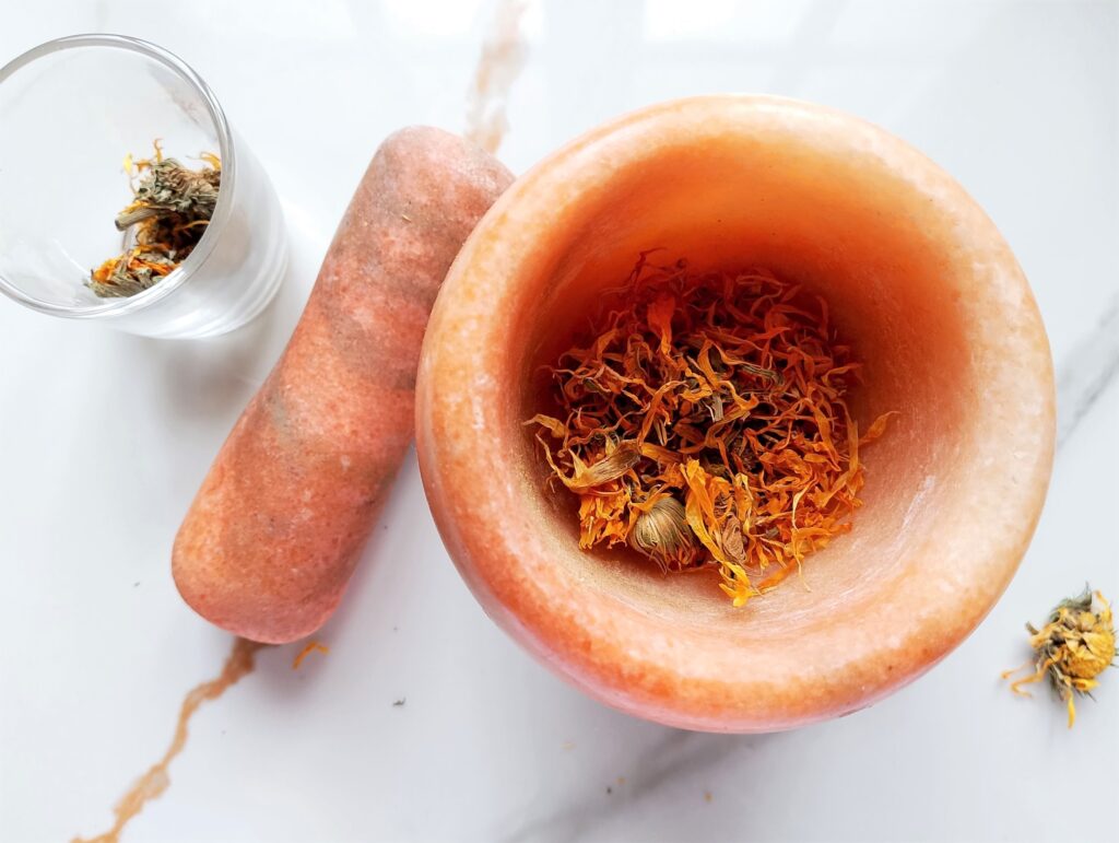 Crushing dried herbs in a mortar