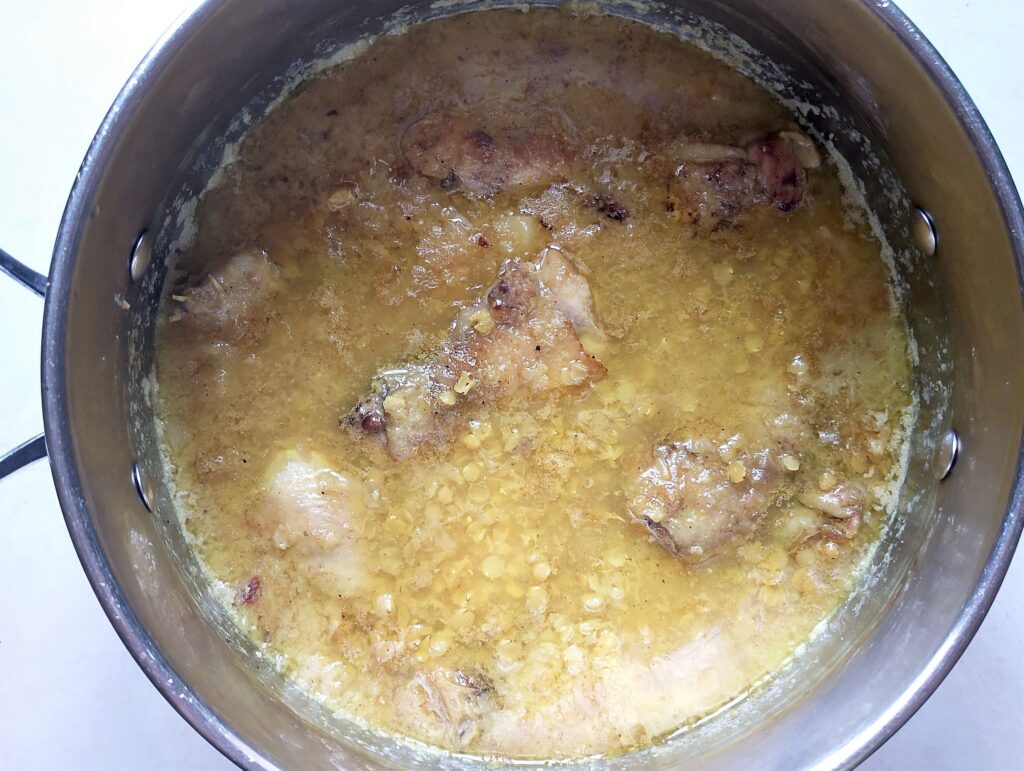 Adding browned chicken pieces to the stew