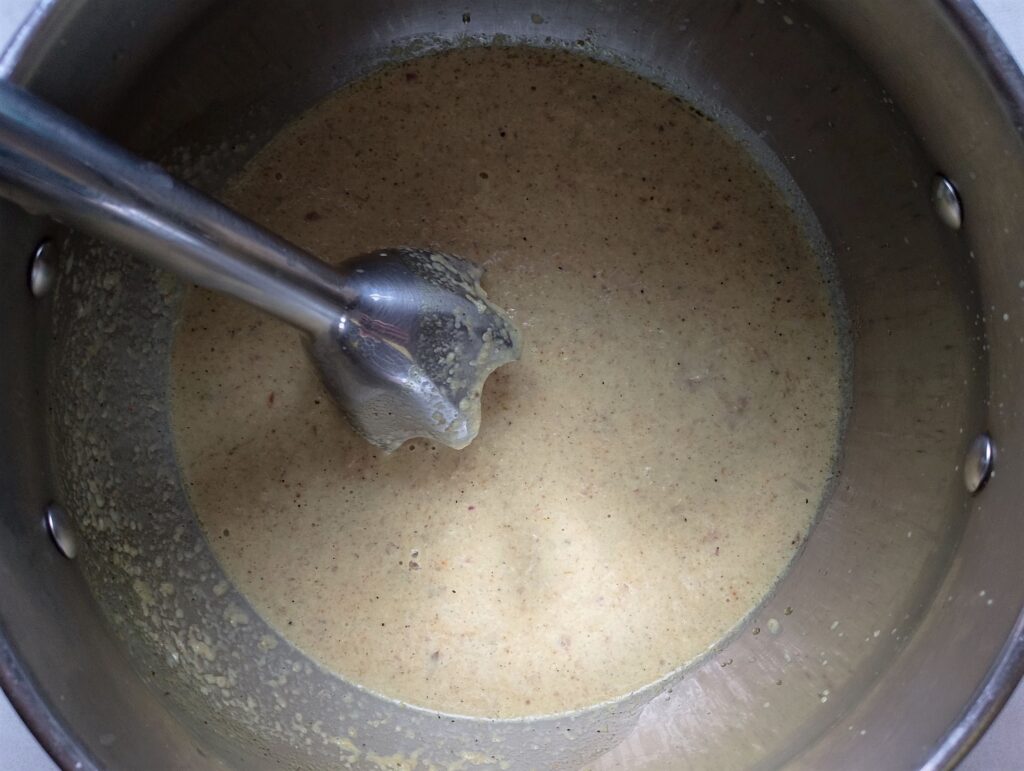 Blending the stew base with a stick blender 