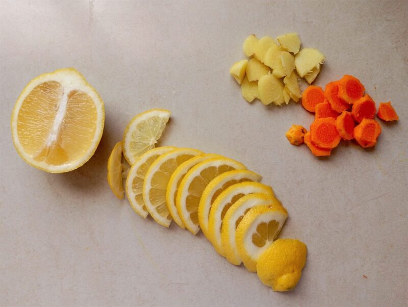 Slicing fresh fruit and spices for fermenting them in raw honey