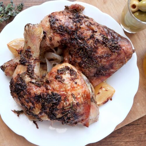 Rosemary lemon roasted chicken legs on a serving plate