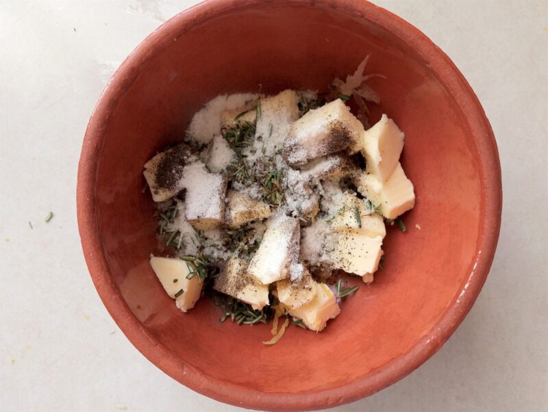 Adding ingredients for rosemary lemon chicken marinade to a bowl