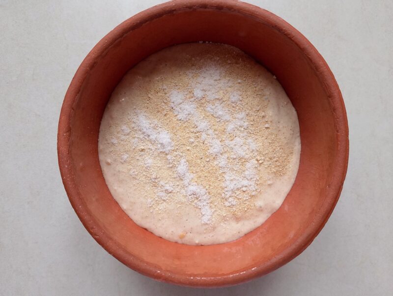 Sprinkling salt and spices on top of discard in bowl
