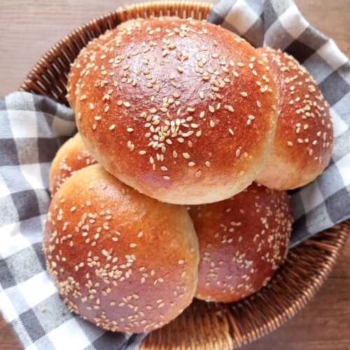 Sourdough discard burger buns in a lined basket