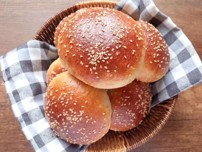 Sourdough discard burger buns in a lined basket