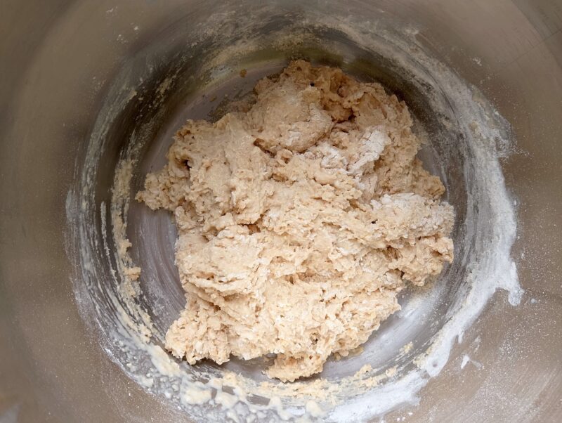 Adding in flour to wet ingredients to make a shaggy dough