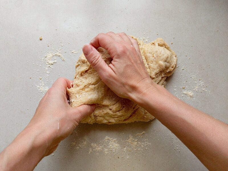 Hands kneading the dough