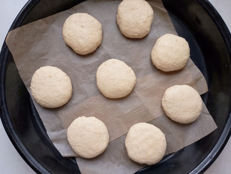 Placing the shaped buns onto baking sheet lined with baking paper