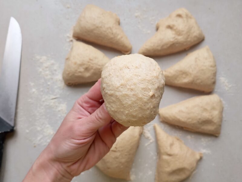 Shaping the dough pieces into rolls