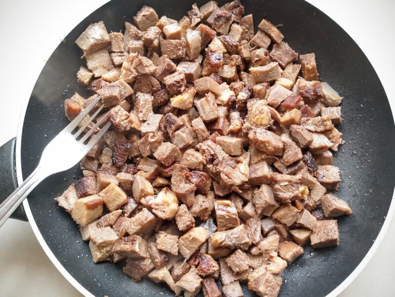 Frying cubed beef tongue in butter until slightly crispy