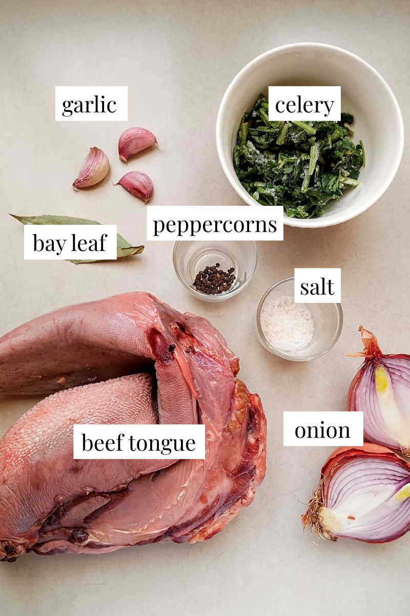 Ingredients for cooking beef tongue arranged on counter