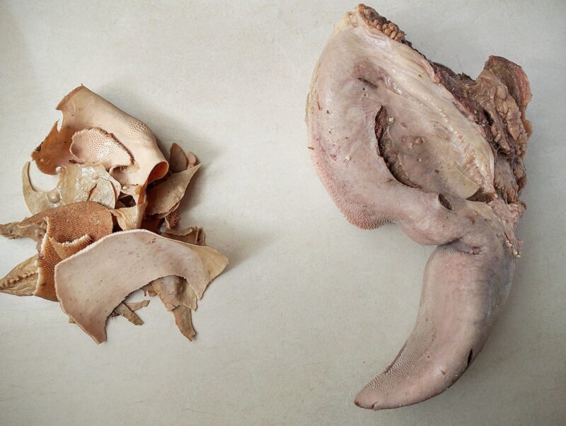 Peeling skin off beef tongue