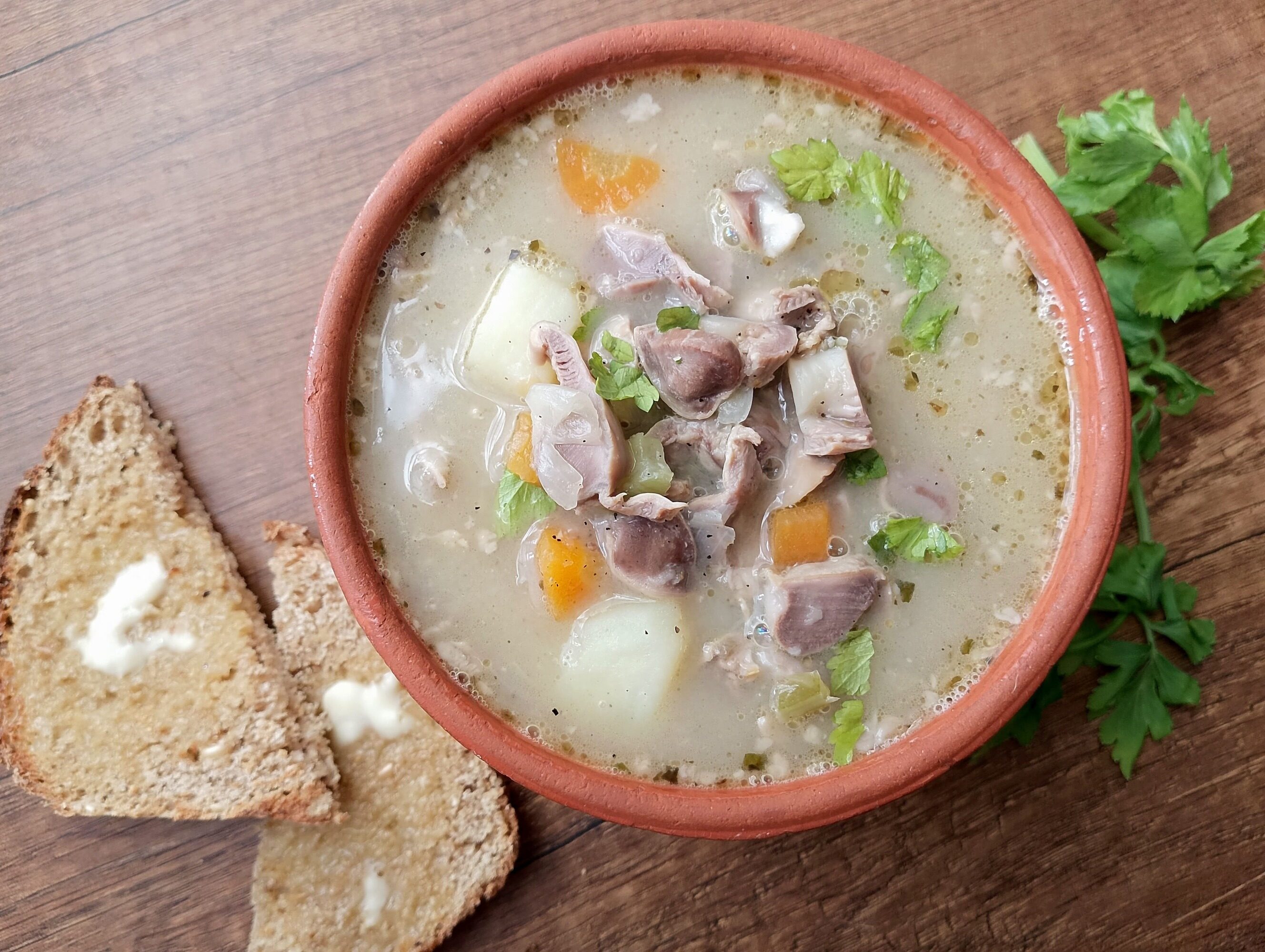 Chicken gizzard soup recipe: bowl of chicken gizzard soup on wooden table
