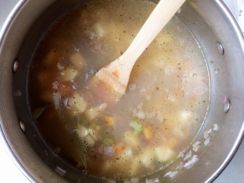 Adding potatoes and bone broth to chicken gizzard soup