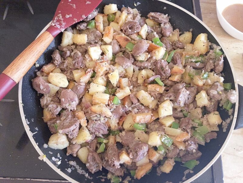 Chicken hearts has in skillet, ready to be served