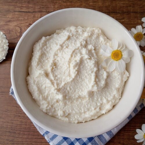 Fromage blanc in bowl on wooden table