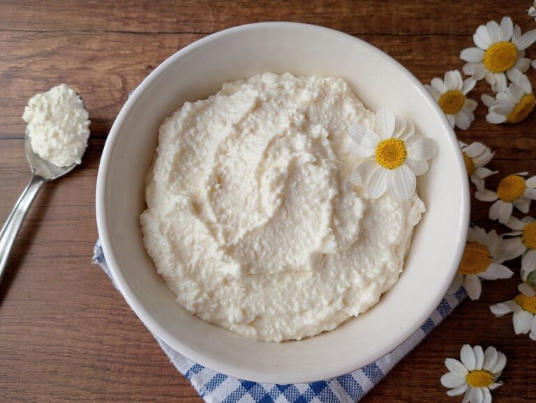 Fromage blanc in bowl on wooden table