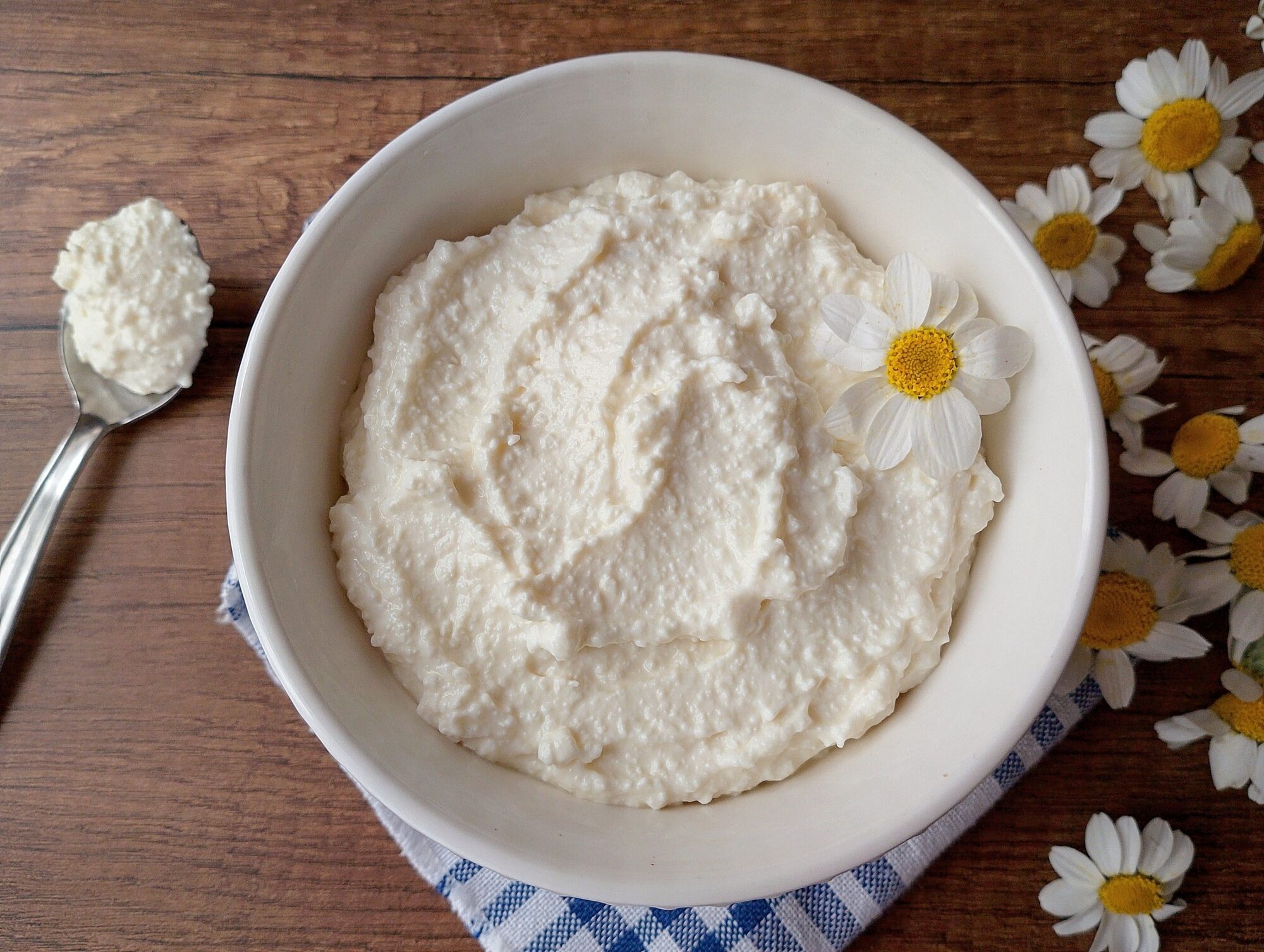 Fromage blanc in bowl on wooden table