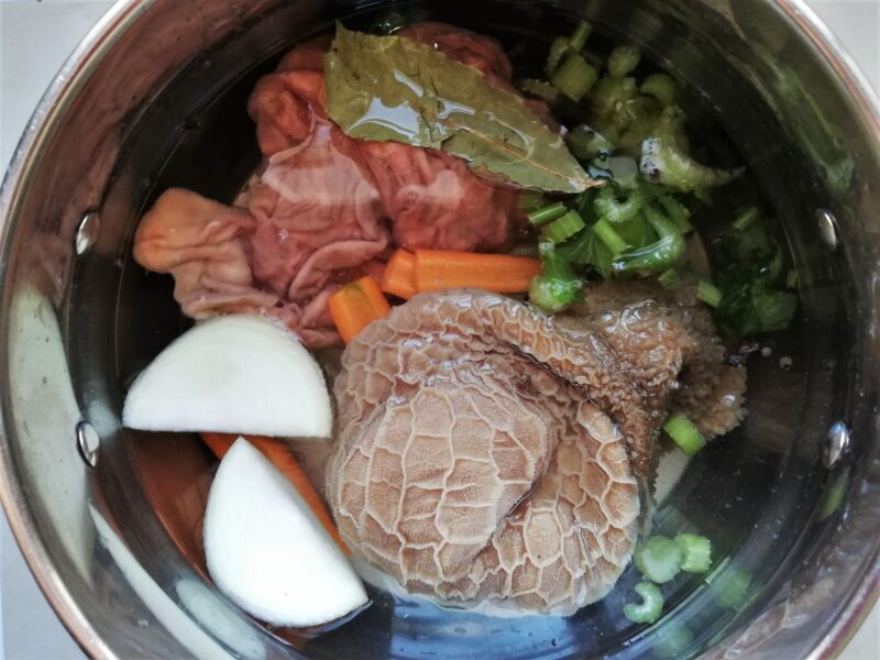 Honeycomb tripe and reed tripe with vegetables, seasonings, and water in pot