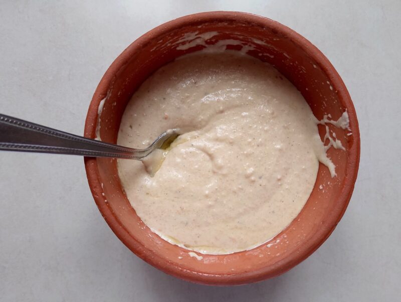 Mixing together the ingredients for sourdough crackers in a bowl