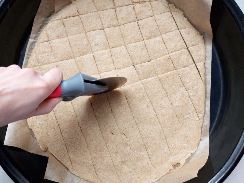Scoring sourdough crackers with a pizza cutter