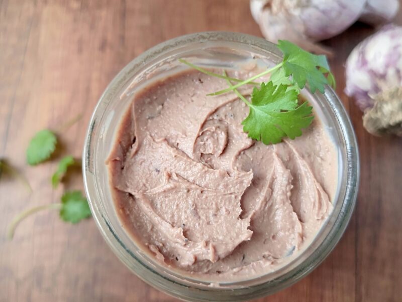 Creamy chicken liver pâté in jar on wooden table
