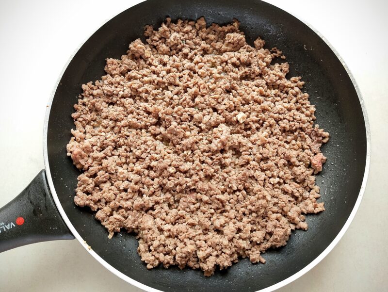 Browning ground beef and ground chicken hearts in skillet