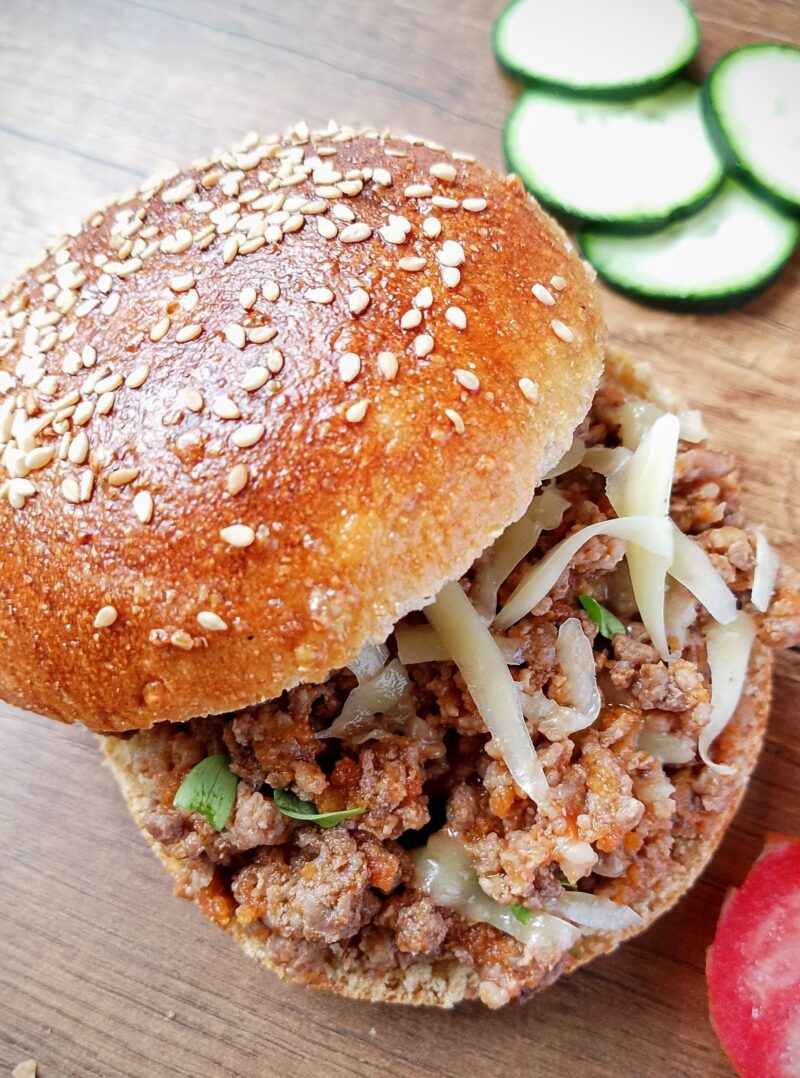 Chicken hearts sloppy joe in burger bun and with melted cheese on top