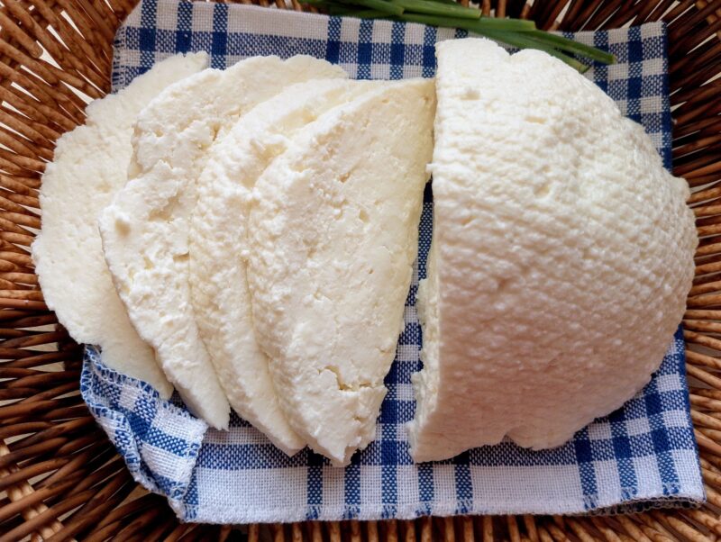 Homemade paneer cheese cut into firm cubes, made without rennet and sliced in a basket