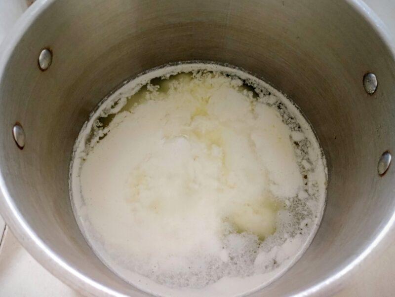 Curds and whey separated in a pot