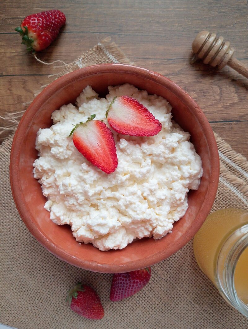 Homemade fresh cottage cheese made without rennet, served in a rustic bowl